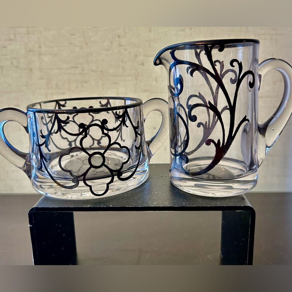 Vintage creamer & sugar bowl w/silver overlay design.